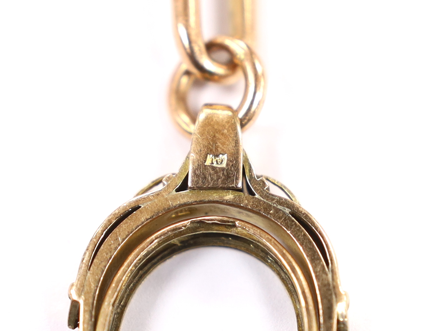 An early 20th century 9ct gold albert, hung with a damaged yellow metal spinning fob, length 43cm